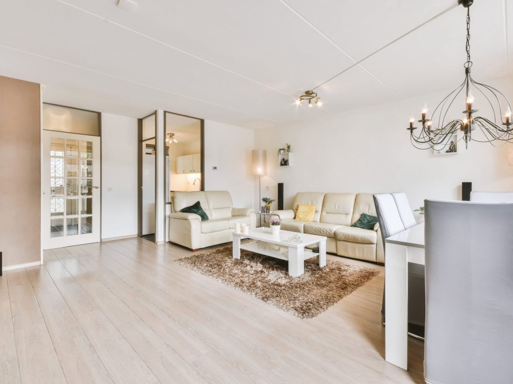Spacious modern living room with elegant furniture and lighting.