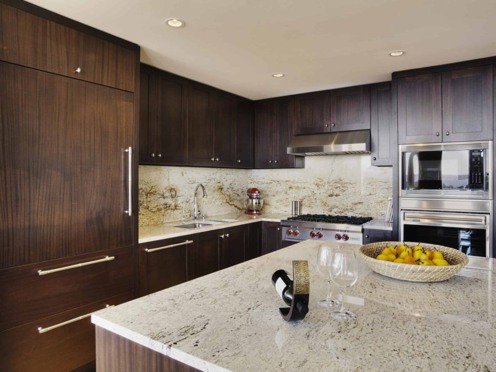 Contemporary kitchen with dark wood cabinets and granite countertops.